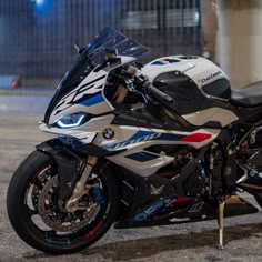 a white and blue motorcycle parked in front of a building