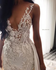 a woman in a wedding dress looking back at the camera