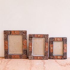 three wooden frames sitting on top of a table