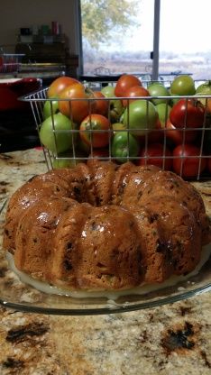 a bundt cake sitting on top of a counter next to fruit in a basket