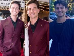 three young men standing next to each other in front of a movie theater and smiling at the camera