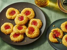 some cookies with jam on them are sitting on a plate