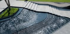 an aerial view of a water feature in the middle of a park with steps leading up to it