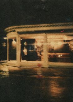 a blurry photo of a store front at night