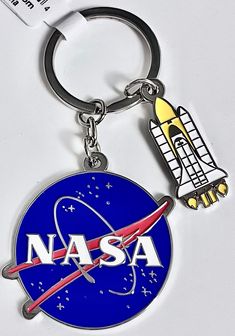 a nasa keychain with a rocket on it