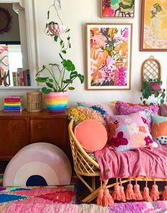 a living room filled with lots of colorful furniture and pictures on the wall above it