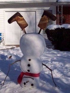 a snowman is standing in front of a house