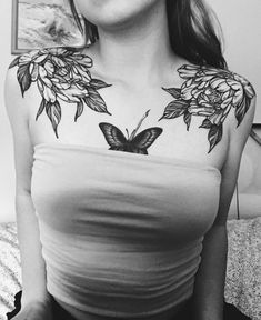 a woman with a butterfly tattoo on her chest