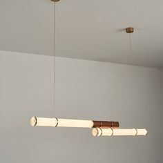 three lights hanging from the ceiling in a room with white walls and wood trimmings