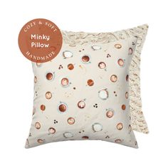 a white pillow with brown circles on it and the words minky pillow manmade