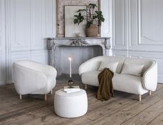 a living room filled with furniture and a fire place in the middle of the room