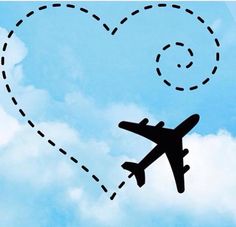 an airplane flying in the sky with a heart shaped trail