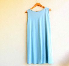 a light blue dress hanging on a wall