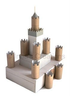 a castle made out of cardboard sitting on top of a white surface with six smaller towers