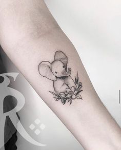 a small elephant tattoo on the arm