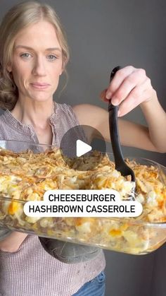 a woman holding a glass casserole dish with cheeseburger hashbrown casserole in it