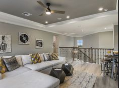 a living room filled with furniture next to a stair case