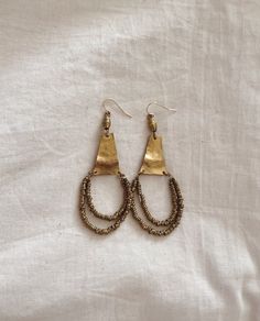 Named after Sintra, Portugal, these beautiful earrings feature hammered brass or sterling silver with recycled metal artisan beads. gold fill or sterling silver ear wires 3"x1.25" Sintra Portugal, Muslin Bags, Hammered Brass, Gold Piece, Beads Handmade, Recycled Metal, Solid Metal, Staple Pieces, Handmade Pendants