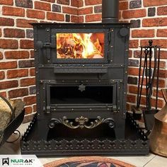 an old fashioned wood stove in front of a brick wall with other items on the floor