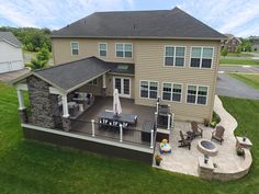 an aerial view of a house with patio and seating area