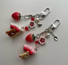 three keychains with different designs on them sitting on top of a white surface