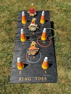 a cornhole game set up in the grass with cones and other items around it