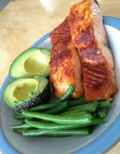 salmon, green beans and avocado on a plate