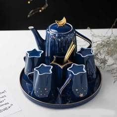 a blue tea set sitting on top of a plate