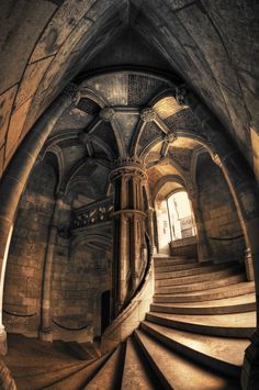 a spiral staircase in an old stone building