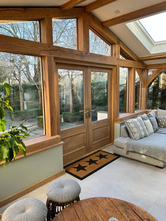 a living room filled with furniture and lots of windows