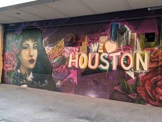 a mural on the side of a building that says houston with an image of a woman and roses