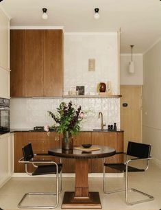 a kitchen with a table and chairs in it