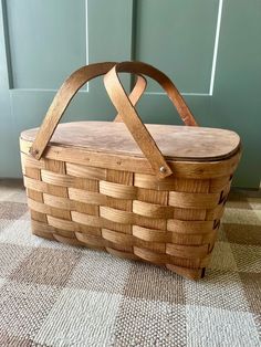 a wooden basket sitting on the floor in front of a door