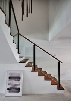 a stair case next to a framed photograph on the wall