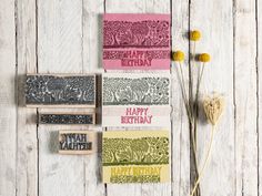 three different types of birthday cards on a wooden table with dried flowers and rubber stamps