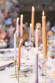 a table with candles and plates on it