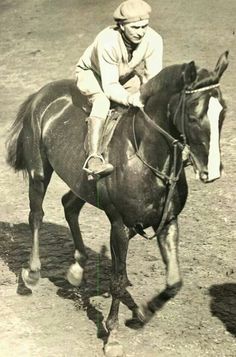 a man riding on the back of a brown horse