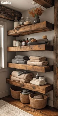 the shelves in this bathroom are made out of wooden planks and have baskets on them