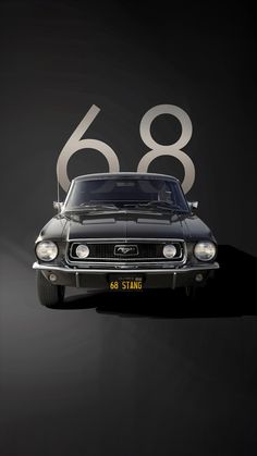 an old black car with the number sixty8 on it's front and side