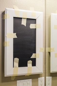 a mirror with some yellow tape on it and a blackboard in the reflection behind it