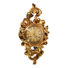 an ornate gold clock with roman numerals