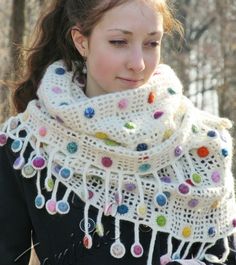 a woman wearing a white knitted scarf and mittens