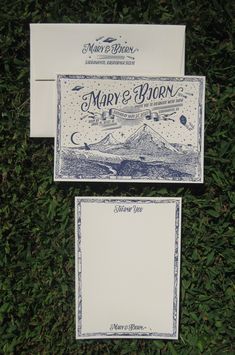 two envelopes with blue and white designs on them, one has a mountain scene