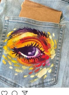 an eye painted on the back of a pair of jeans