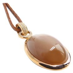 Thomas Leyser is renowned for his contemporary jewellery designs utilizing fine coloured gemstones and diamonds. This pendant in 18k red gold is set with a fine oval brown Moonstone Cabouchon 66,03ct. in top quality (36x25mm). It is accentuated by 100 diamonds brillant cut 1,2-1,5mm, pavé (0.95cts, G/VS). Marcasite Jewelry, Contemporary Jewelry Design, Handmade Gold Jewellery, Silver Necklace Set, Sparkle Necklace, Heart Necklace Diamond, Pretty Necklaces, Gold Jewelry Indian, Contemporary Jewellery