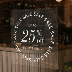 a store window with the sale sign 25 % off everything