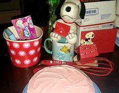 a cake with frosting sitting on top of a table next to a dog figurine