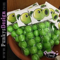 green candies wrapped in plastic sitting on top of a brown bowl filled with candy