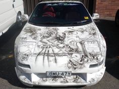 a white car with some drawings on it