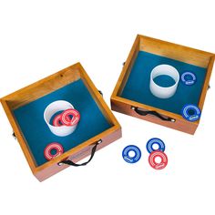 two wooden boxes filled with different types of rings and magnets on top of each other